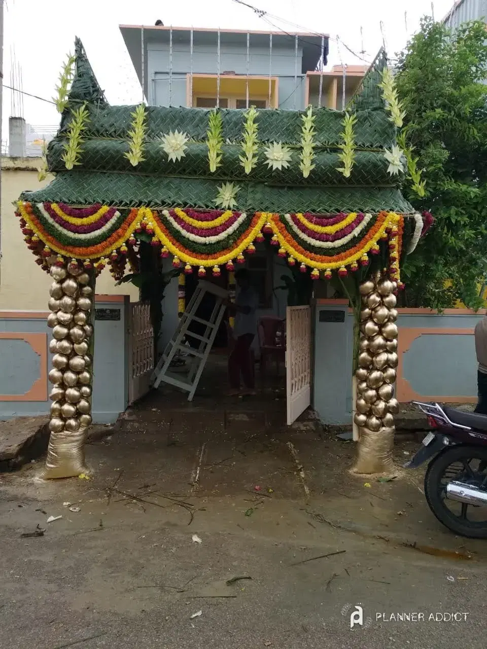 Chappara with gold pillars and marigold garlands